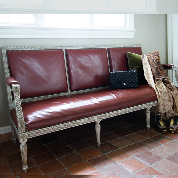 Vintage Terra Cotta Leather Sofa - features rich tufted leather with a unique patina from time and use. This impressive sofa features elegant scrolled arms and comfortable three-seat configuration